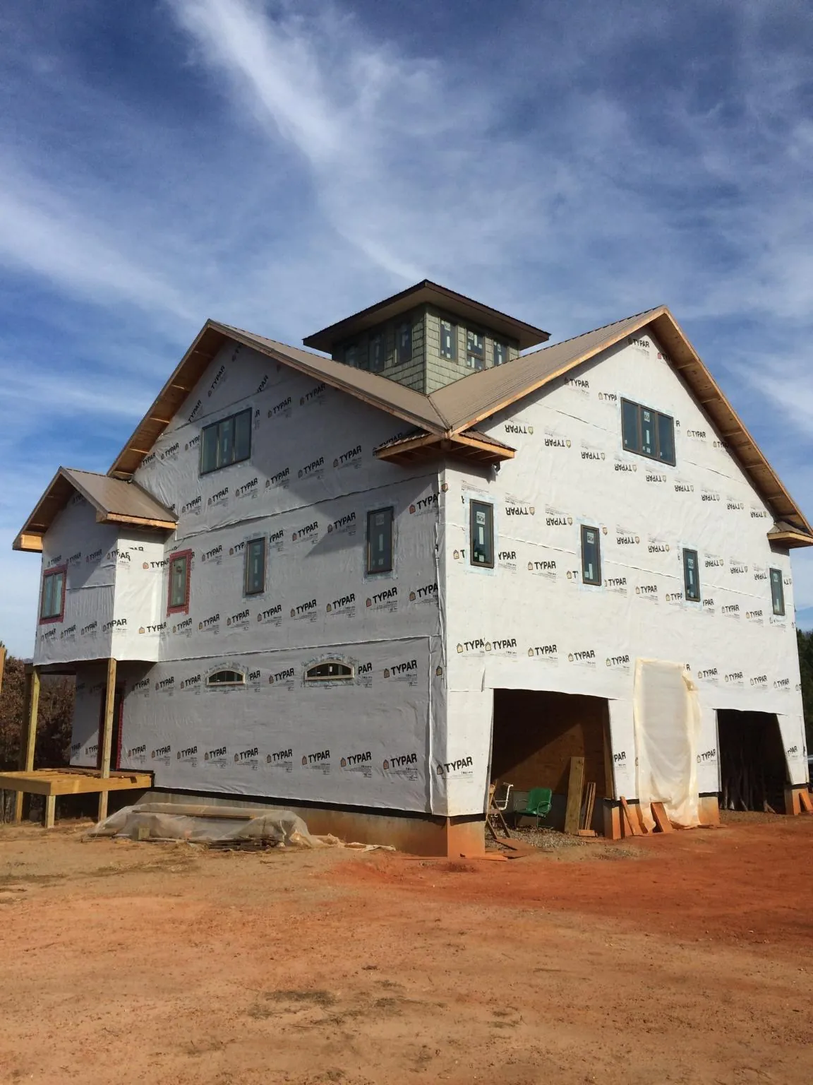 New two story house under construction with a cupola and gabled roofs in Big Rapids